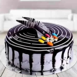 vanilla confetti gems cake with colorful toppings and creamy layers