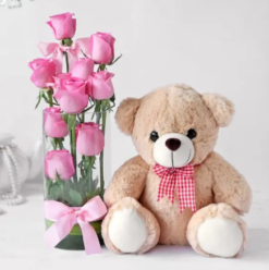 Pink roses in vase with teddy bear romantic gift