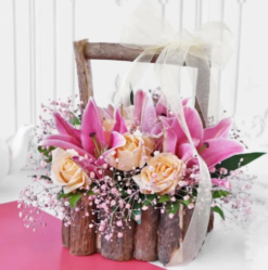 Fresh rose and lily wooden basket arrangement for gifting