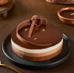 tripluxe chocolate mousse cake with triple layers and smooth creamy texture