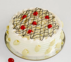 alpine white forest bliss cake with white chocolate layers and cherry topping